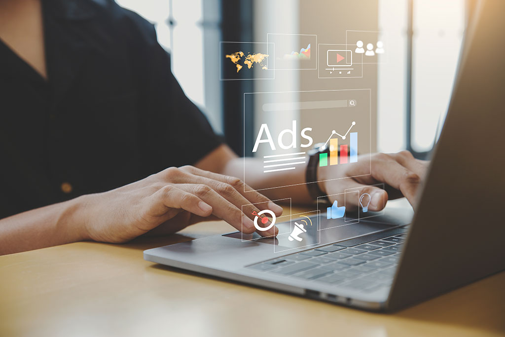 Man optimizing ads on a laptop
